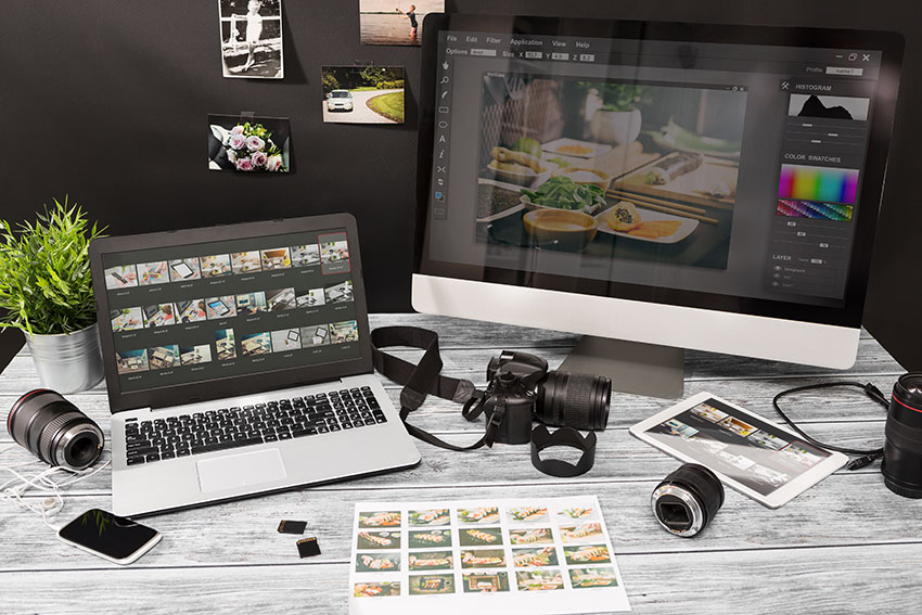 Corporate photography setup with a laptop, camera, and desk items of Nashville Corporate Media