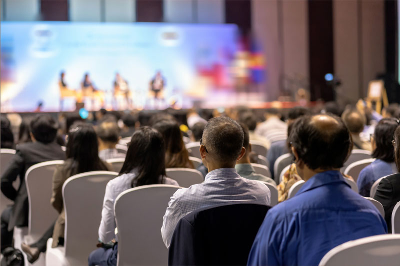 A group of people sitting in a tradeshow photographed by Nashville Corporate Media