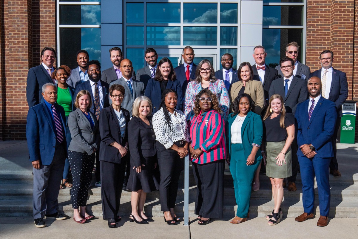 corporate group shot of people standing in front of a building taken by Nashville Corporate Media