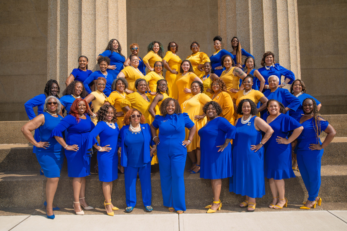 corporate group shot of a large group of women in blue and yellow taken by Nashville Corporate Media